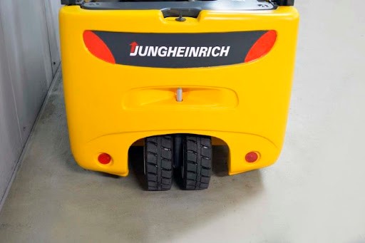 Tylne koła reach trucka Jungheinrich z podwójnymi oponami na betonowej powierzchni